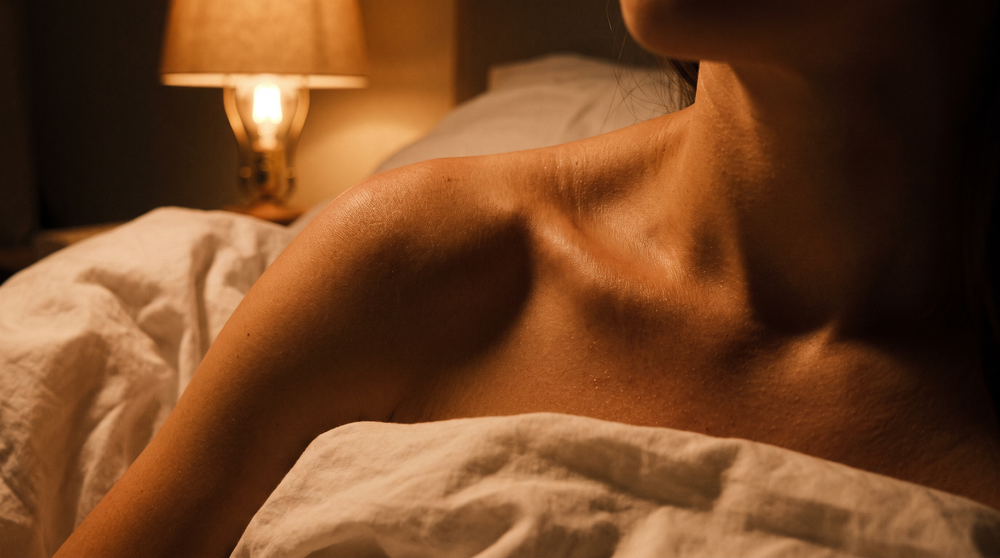 Warm amber lamplight on shoulders at evening rest